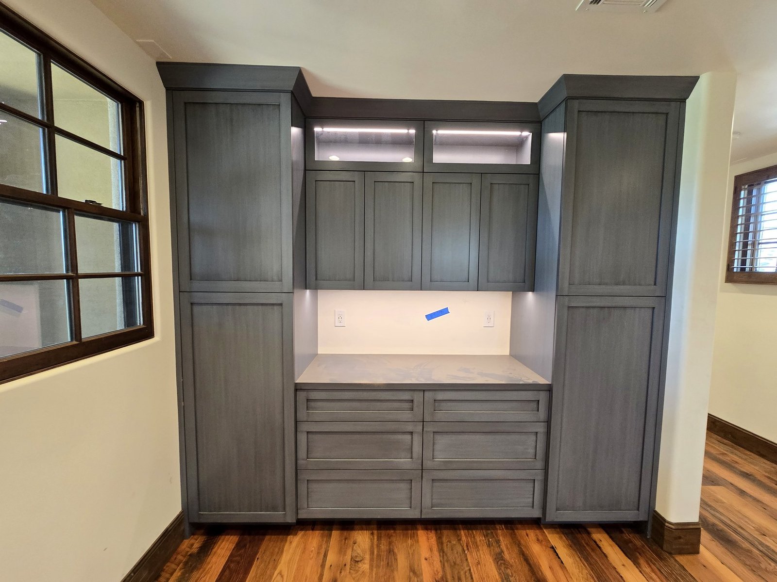 Wardrobe and built-in cabinet installation with accent lighting and drawers